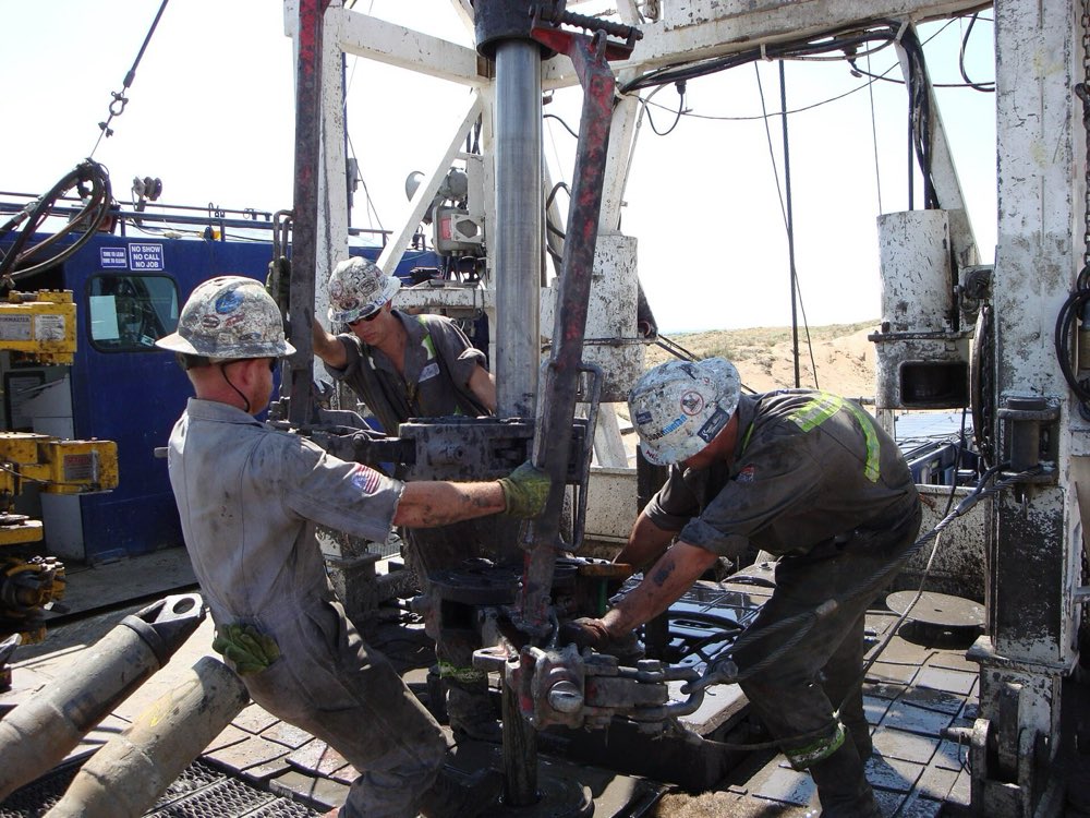 Drilling crew working the rig floor in FR coveralls