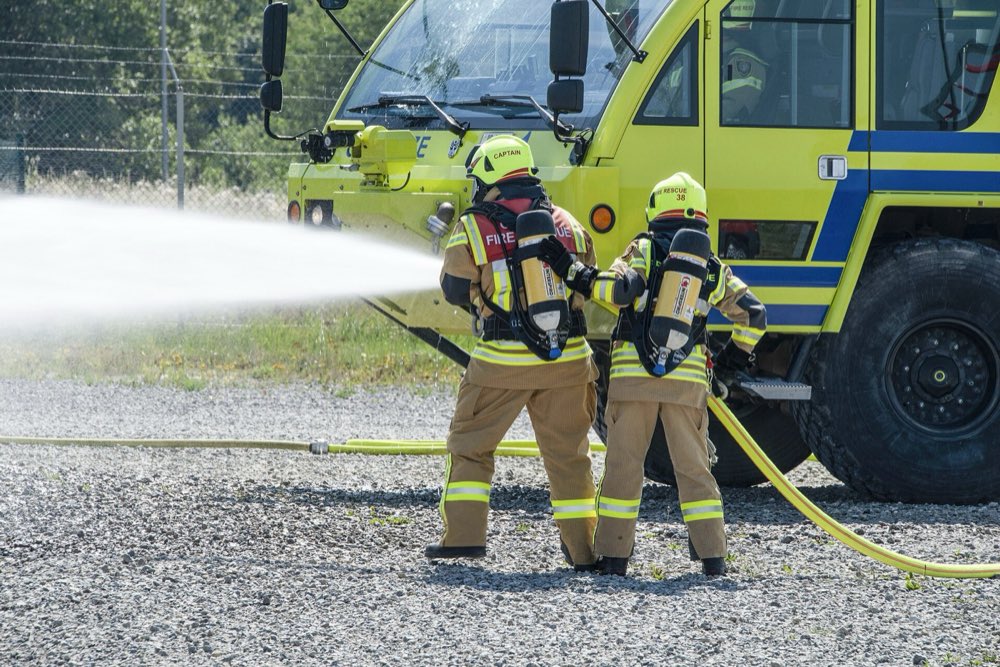 Firefighters in turnout gear on a training ground