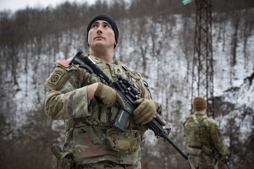 Person wearing a flame resistant combat uniform